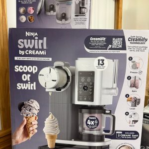 The Raffle #??? - Ninja Swirl display box showcases the machine, two cones, features, accessories, and instructions. Ideal as a raffle prize, it highlights soft serve settings and customization options.