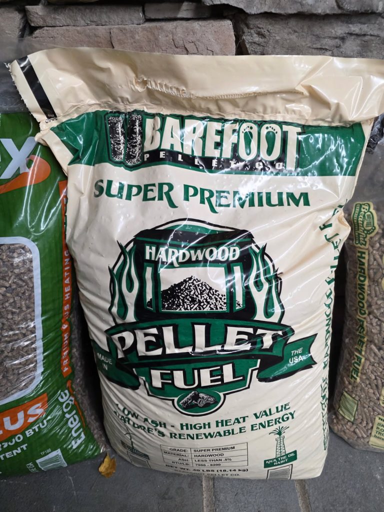 A large beige bag promotes Raffle #605 – 2 Tons of Wood Pellets, Winner's Choice of Brand. Featuring green and black accents, this prize highlights high heat value and is ideal for raffles or as a winner’s choice reward.